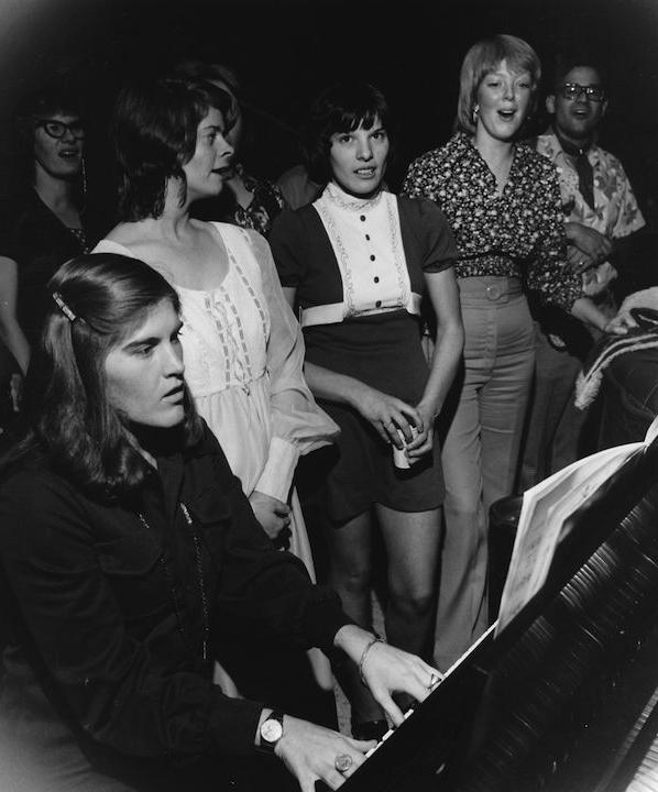 Students singing and playing the piano