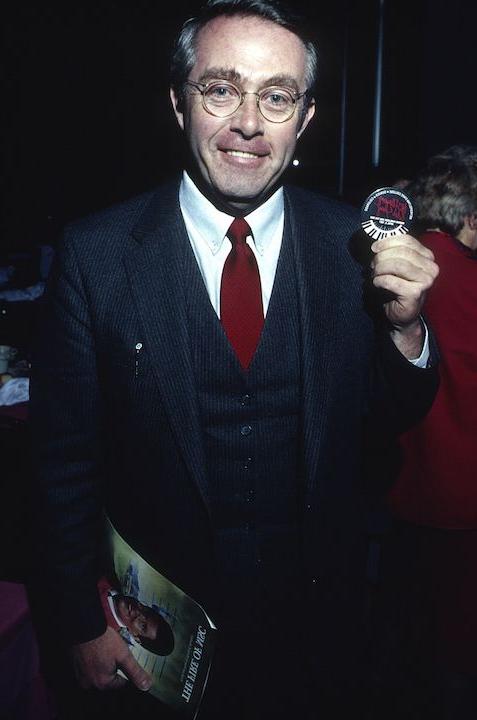 Man holding souvenir from Mark Maslisch's first performance of 